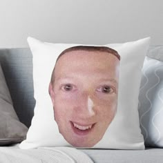 a man's face is shown on a pillow with the image of him smiling