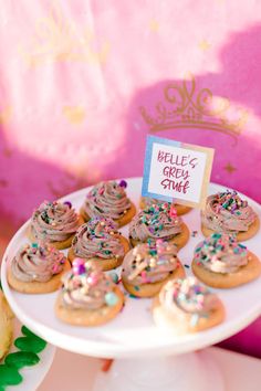 there is a plate full of donuts with frosting and sprinkles