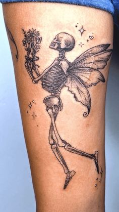 a woman with a skeleton tattoo on her thigh holding a flower in one hand and a knife in the other