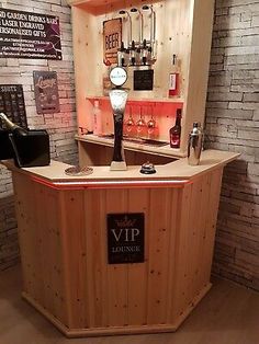 a small bar in the middle of a room with brick walls and wood flooring