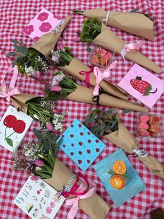 flowers and greeting cards laid out on a picnic table with gingham checkered cloth