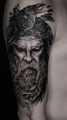 a man's arm with a black and white tattoo on it, depicting a bearded man