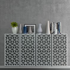 the sideboard is decorated with white vases and books