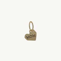 a gold heart charm with the word mom on it's front and back side