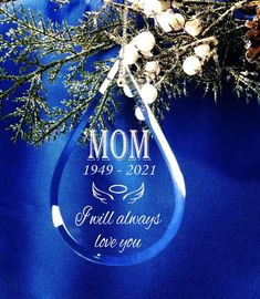 a blue glass ornament with the words dad hanging from it's side