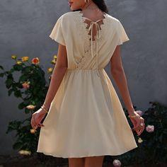 The Anna-Kaci Dress Is Detailed With A Fun Overlap Tie-Back Design. Features A V Neckline, Solid Color, Flutter Sleeves, Crochet Lace Back Detail, Flowy Skirt, And Above Knee Length. Pair It With Sunnies And A Clutch Bag For A Minimalist Look. Materials: 100% Soft Polyester Measurements: Product Length Is 35"-37" In 4-6-Small | Waist: 25”-26.5” In | Chest: 33”-34.5” In | Hips: 35”-36.5” In 6-8-Medium | Waist: 26.5”-28” In | Chest: 34.5”-36” In | Hips: 36.5”-38” In 8-10-Large | Waist: 28”-29.5” I A-line Dress With Lace Trim For Vacation, Elegant Flutter Sleeve Mini Dress For Vacation, A-line Mini Dress With Lace Trim For Beach, Beige Flutter Sleeve Beach Dress, Beige Flutter Sleeve Dress For Beach, Short Sleeve Solid Dress With Lace Trim, Solid Dress With Lace Trim And Short Sleeves, Solid Short Sleeve Dress With Lace Trim, Solid Color Short Sleeve Dress With Lace Trim