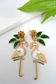 Stand out in the crowd with a pair of high polished flamingo earrings featuring epoxy finish and rhinestone accents. Length: 2.5" Flamingo Earrings, Rhinestone Earrings, Flamingo