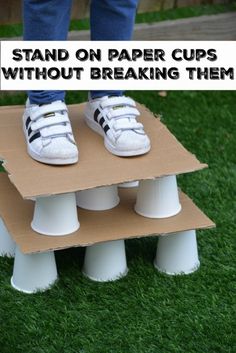 a person standing on top of a cardboard box with white shoes on it and the words stand on paper cups without breaking them