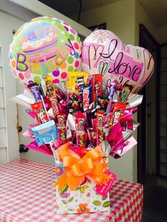 a bouquet of candy and balloons on a table