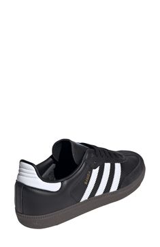 From the soccer pitch to the streets, this always-original sneaker maintains its legacy with luxe leathers and iconic 3-Stripes at the sides. Removable insole Leather upper/textile lining/synthetic sole Imported Black Adidas Sneakers With Perforations, Black Striped Synthetic Sneakers, Soccer Pitch, Adidas Black Cushioned Sneakers, Adidas Samba Sneakers, Adidas Samba, The Streets, Womens Sneakers, Leather Upper