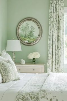 a bedroom with green walls and white bedding