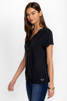 Crafted from a super soft modal blend with a hint of stretch, the Modal Jersey Button Neck Tee offers a modern take on classic sportswear. Featuring a curved V-neckline with decorative buttons, this short sleeve tee creates a relaxed fit with a custom feel. Pair with linen shorts and fashion sneakers to take on the warmest days. Johnny Was Women's Modal Jersey Button Neck T-Shirt in Black Beauty White, Size Small, Linen Solid Henley Neckline Tops For Everyday, Casual Henley Neckline Tops For Gatherings, Casual Modal Top With Relaxed Fit, Casual Modal T-shirt, Casual Stretch Top With Henley Neckline, Casual Henley Neckline Tops With Stretch, Casual Henley Neckline Tops For Loungewear, Casual Modal Tops For Layering, Stretch Henley Neckline Top For Loungewear