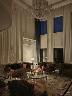 a fancy living room with chandelier and couches