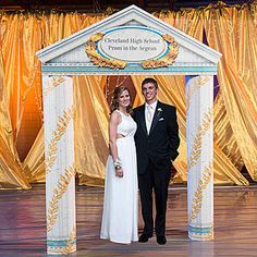 a man and woman standing in front of a stage