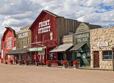 an old western town with red and green buildings