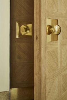 an open door with brass handles and knobs