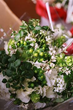 a bouquet of white flowers and green leaves