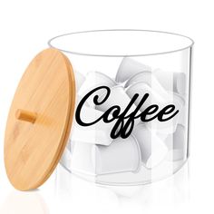 a glass container with a wooden lid and the word coffee printed on it next to ice cubes