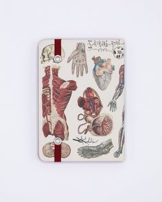 a notebook covered in medical images and writing on white paper with red string attached to the cover