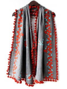 This grey unisex stole/scarf is crafted in organic khadi soft cotton. It is embroidered with minute aari work in flower bunch motif.It is embellished with dyed cotton tassel lace. Protect your self from sun by wraping it around the face. This fresh gray/orange stole is perfect for you casual outfit . The khadi fabric gets softer after every wash. Color: Grey Fabric: 100% Khadi - Cotton Base Fabric Work Details: Embroidered, embellished with fancy laces, jute laces, and dyed pom pom laces. Meausr Red Cotton Dupatta For Spring, Spring Red Cotton Dupatta, Traditional Cotton Dupatta With Tassels, Cotton Dupatta With Embroidered Border, Folk Style Cotton Embroidered Dupatta, Traditional Cotton Shawl For Spring, Embroidered Cotton Folk Dupatta, Folk Style Embroidered Cotton Dupatta, Red Cotton Dupatta With Floral Embroidery