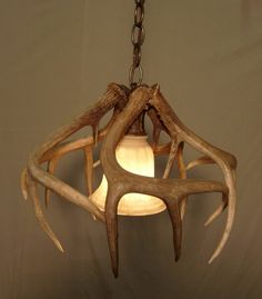 a deer antler lamp hanging from a chain