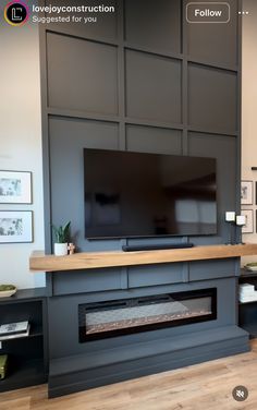 a flat screen tv mounted to the side of a wall next to a fire place