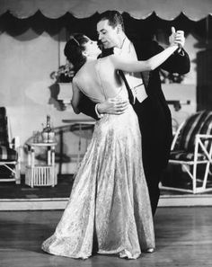 a man and woman are dancing together on the dance floor in an old - fashioned photo