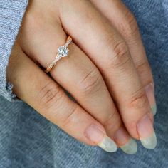 a woman's hand with a diamond ring on it