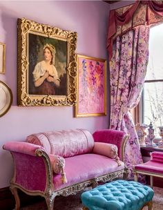 a living room filled with furniture and paintings on the wall