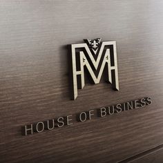 the house of business logo is shown on a metal surface with wood grained background