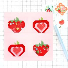 four pieces of paper cut out to look like strawberries