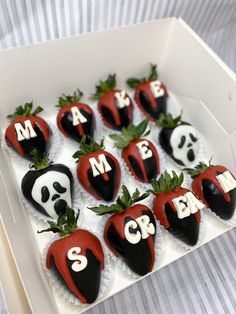 some chocolate covered strawberries in the shape of hearts with faces and letters on them