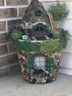 a small house made out of rocks and plants