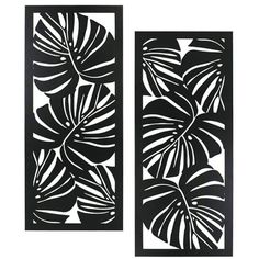 two black and white wall art panels with leaves on the sides, one is made out of