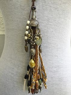 Pearl Strand with Multi Tassel. Hand crafted by Amy Kaplan. Amy is a truly talented artisan who has been hand crafting high quality custom jewelry for cowgirls with discriminating taste. You'll have a unique custom piece of western jewelry that stands out from the crowd. Glass pearl strand, multi tassel, pewter and Indian silver plated brass beads, horn and bone accents. Handmade Western Style Jewelry For Festival, Adjustable Fringe Jewelry For Festivals, Handmade Western Jewelry For Festival, Bohemian Lariat Jewelry For Western-themed Events, Western Style Handmade Festival Jewelry, Unique Dangle Tassel Jewelry, Rustic Handmade Jewelry For Western-themed Events, Unique Tassel Jewelry For Festivals, Adjustable Bohemian Fringe Jewelry