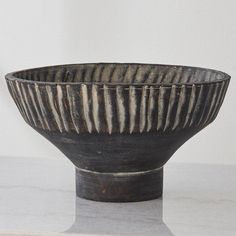 a black bowl sitting on top of a white counter