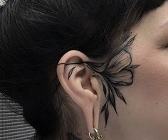 a woman with tattoos on her face and ear