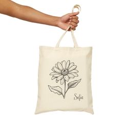 Carry nature's beauty with the Personalized Floral Tote Bag--a charming and Cute Flower Tote Bag perfect for any occasion. Featuring a stunning Birthflower design, this Vintage Flower Tote Bag makes an ideal Gift for Her. With its delicate botanical details, this Botanical Tote Bag combines style and functionality, making it the ultimate Cute Bag for everyday use. This 100% cotton bag comes in one size - 15" x 16"- perfect for everyday wear. While the canvas material will show off your designs i Botanical Style Canvas Bag For Daily Use, Botanical Rectangular Canvas Bag For Daily Use, Botanical Style Rectangular Canvas Bag For Daily Use, White Botanical Bags For Daily Use, White Botanical Bag For Daily Use, White Botanical Rectangular Bag, Everyday Botanical Rectangular Bag, Botanical Style Rectangular Everyday Bag, White Botanical Bags For Everyday