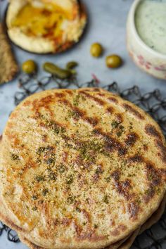 two flat breads sitting on top of a cooling rack