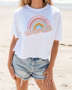 Express your love for America and all the good times you've had over the years by wearing this fun rainbow graphic tee! There's hardly any place that you can't wear it, so go ahead and grab it while you can! All you need to style it with are some denim shorts, multi-color sneakers, and a few other accessories to compliment the look. White Vsco T-shirt With Text Print, Trendy Rainbow T-shirt For Summer, Trendy Rainbow Summer T-shirt, Trendy Rainbow Top For Pride, White Screen Print T-shirt For Pride, Summer Rainbow Graphic Print Tops, Rainbow Graphic Print Top For Summer, Rainbow Graphic Print Tops For Summer, White Cotton T-shirt With Rainbow Print