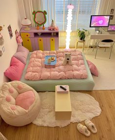 a bedroom with pink and blue bedding, white rugs and wooden flooring