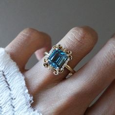 Read about our payment plans before proceeding. Make a lasting impression with the Isis London Blue Topaz Scroll Diamond Ring and its saturated deep blue color. Crafted from 14K gold or 18K solid gold, this stunning piece features a natural london blue topaz centerpiece and delicate baguette diamonds, inspired by the iconic architecture of New York City. All order comes in a Tippy Taste ring box. This ring is handmade and designed in NYC. 14K or 18K solid gold Natural 9*7mm London Blue Topaz Nat Iconic Architecture, Fall Rings, London Blue Topaz Ring, Baguette Diamonds, Fashion Baby, London Blue Topaz, Blue Topaz Ring, Nature Bracelets, Baguette Diamond