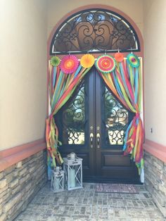 an image of a door that is decorated with colorful ribbons and decorations on the outside