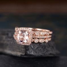 two wedding bands with an morganite and diamond ring set on top of each other