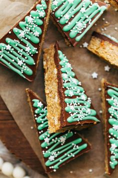 several pieces of cake with green icing and white sprinkles