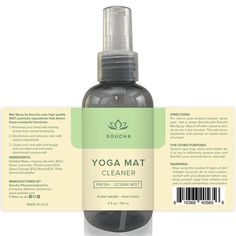 a bottle of yoga mat cleaner sitting on top of a white table next to a tag