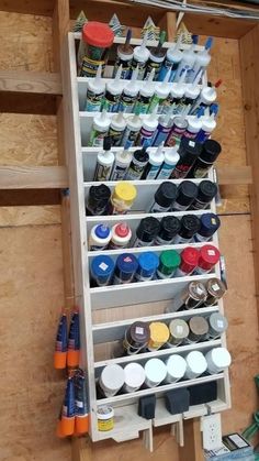 a shelf filled with lots of paint and other crafting supplies on top of wooden pallets