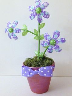 a potted plant with purple flowers and polka dots