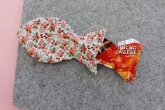 a bag of taco cheese sitting on top of a gray surface next to a fish