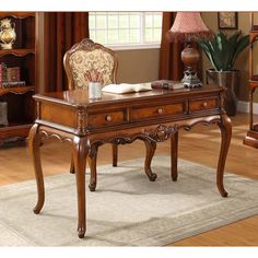 a wooden desk sitting on top of a carpeted floor next to a book shelf